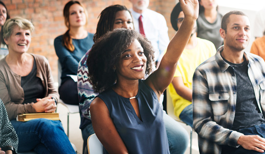 Student raising hand in class