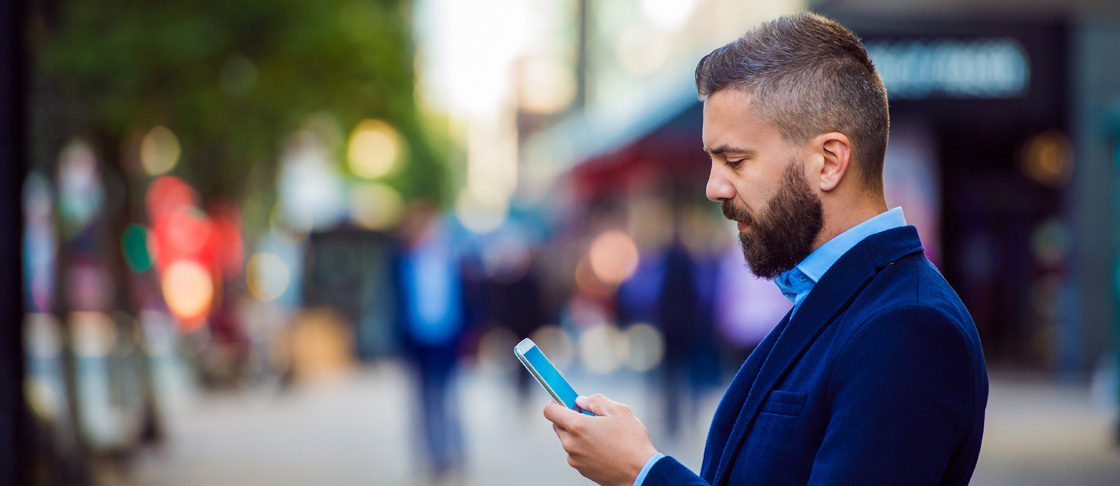 Business Professional looks at mobile device